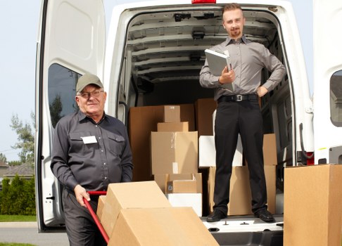 Movers wrapping fragile belongings with protective materials