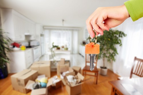 Removal team using safe lifting practices during a house move