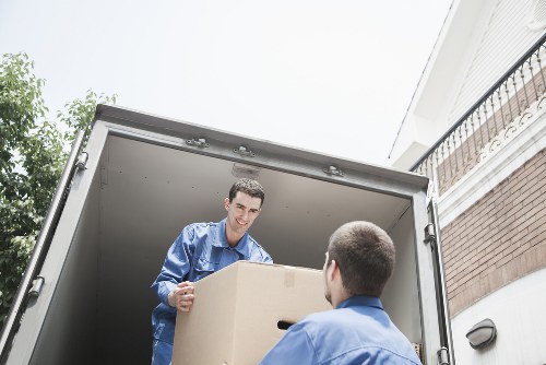 Helper carrying boxes during a move in Merton