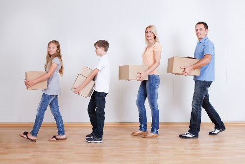 Professional office movers handling desks and equipment during a Merton relocation